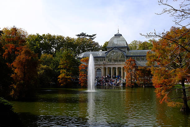 Crystal Palace, Buen Retiro Park, Madrid Madrid, Spain - October 25, 2015: Tourists and locals gather outside the Crystal Palace (Palacio de Cristal) in the Retiro Park in Madrid on a cold Autumn morning. Designed by architect Ricardo Velázquez Bosco, it was built in 1887 to exhibit flora and fauna from the Philippines. palacio de cristal photos stock pictures, royalty-free photos & images