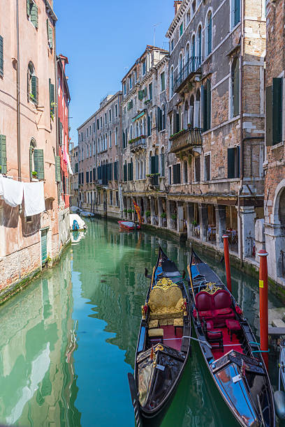 istock Two anchored gondolas in Venice. Venice canal with anchored gond 537864634