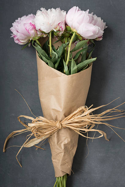 Peonies wrapped in floral paper