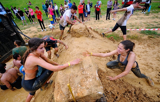 Oviedo, Spain - June 5, 2016: Storm Race, extreme obstacle race in June 5, 2016 in Oviedo, Spain. People jumping, crawling,passing under a barbed wires or climbing obstacles during extreme obstacle race.