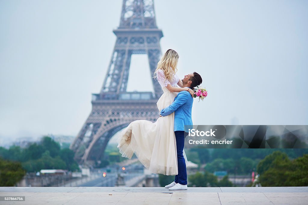 Just married couple in Paris, France Just married couple in Paris, France. Beautiful young bride and groom near the Eiffel tower. Romantic wedding in Paris concept Elopement Wedding Stock Photo