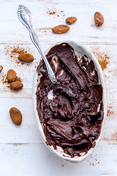 istock Melted chocolate with metal spoon in ceramic bowl . 537867994