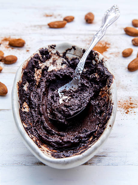 istock Melted chocolate with metal spoon in ceramic bowl . 537868166