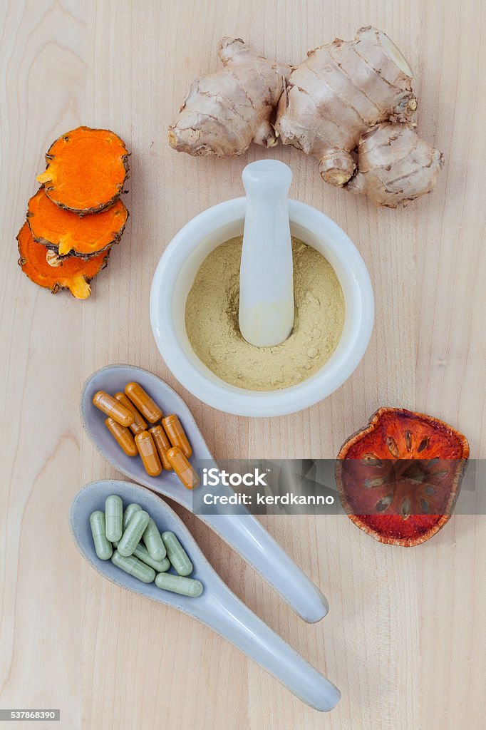 Alternative health care fresh herbal  ,dry and herbal capsule. Alternative health care fresh herbal  ,dry and herbal capsule with mortar on wooden background. Acupuncture Stock Photo