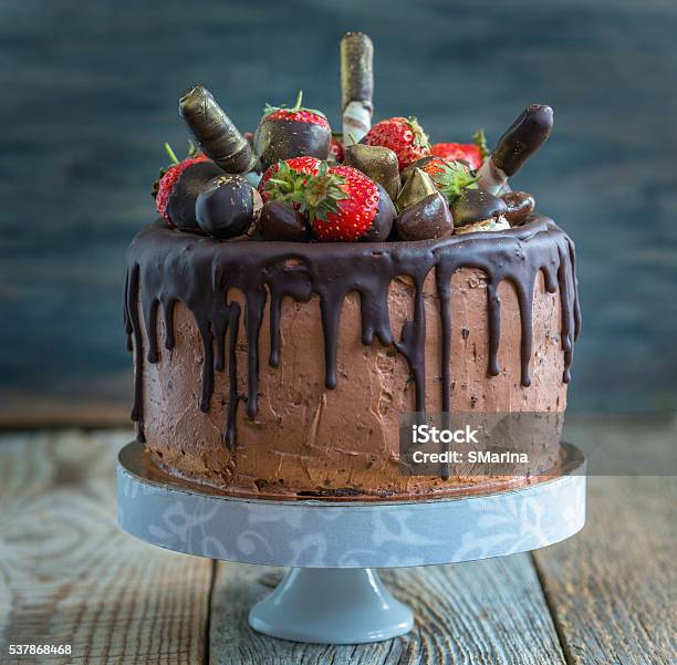 Chocolate Cake With Strawberries Wafer Rolls And Candies Stock Photo - Download Image Now