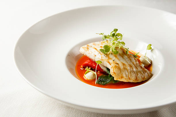 Grilled turbot, tabouli, sweet pepper sauce and summer vegetables. Grilled turbot, tabouli, sweet pepper sauce and summer vegetables. White dish. turbot stock pictures, royalty-free photos & images