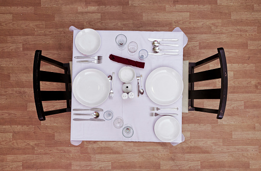 Top view of luxurious meal table set in restaurant.