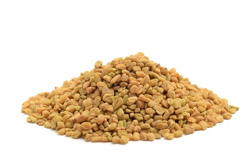 Fenugreek seeds isolated on a white background.