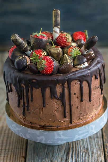 istock Cake decorated with strawberries, chocolates and wafer rolls. 537869056