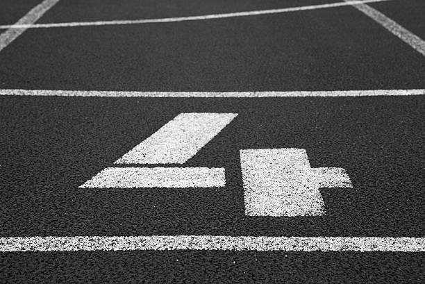 istock Number four. White track number on red rubber racetrack 537869452