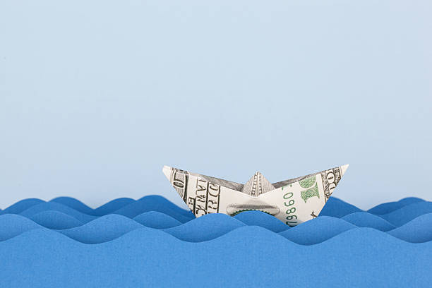 Dollar boat swimming on paper waves