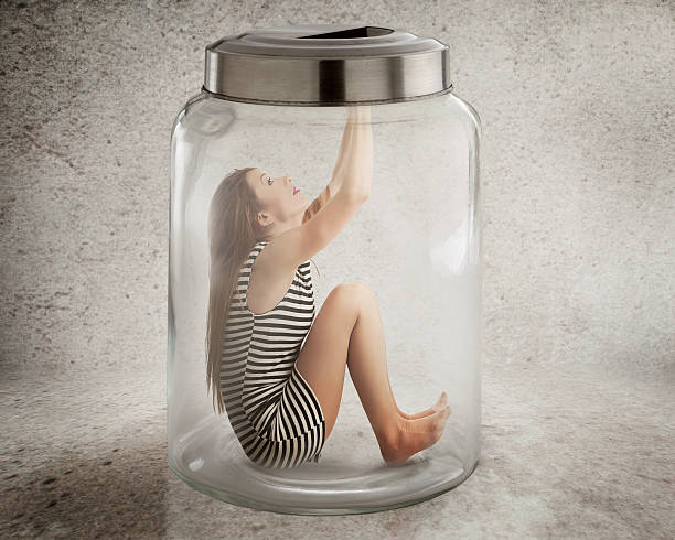 istock Young lonely woman sitting in glass jar 537869633