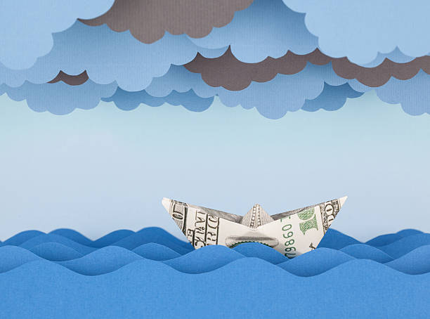 istock Dollar boat in storm. Paper waves and clouds 537869850