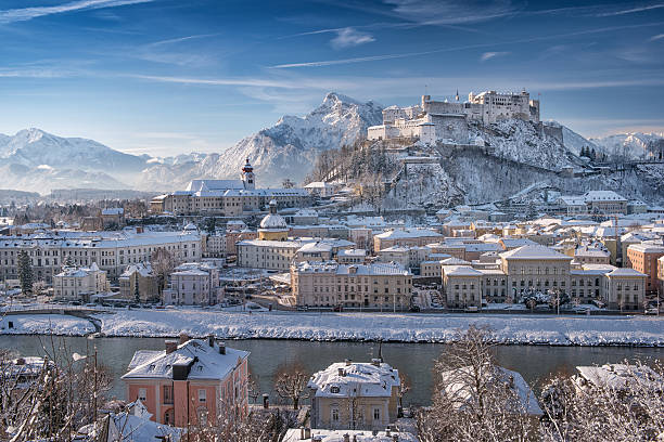 Salzburg with Hohensalzburg covered in Snow, Austrian Alps Unique panoramic shot of Salzburg with the famous Hohensalzburg Festung covered in fresh Snow. Beautiful Austrian Alps Backdrop. salzburger land stock pictures, royalty-free photos & images