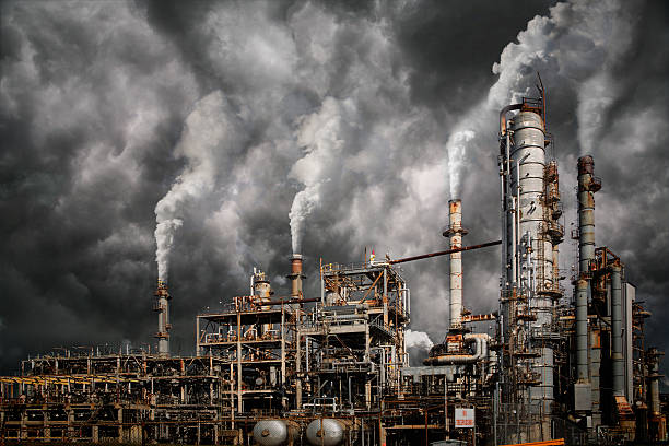 Industrial pollution Industrial plant emitting fumes and creating pollution smoke stack stock pictures, royalty-free photos & images