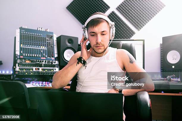 Dj Listening Music In Sound Recording Studio Stock Photo - Download Image Now - DJ, Men, Producer