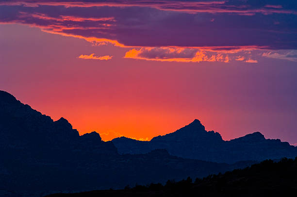 Sunset in Sedona Arizona - Landscape scenic with intense colorful sky at sunset with silhouetted mountain.  Sedona, Arizona, USA.