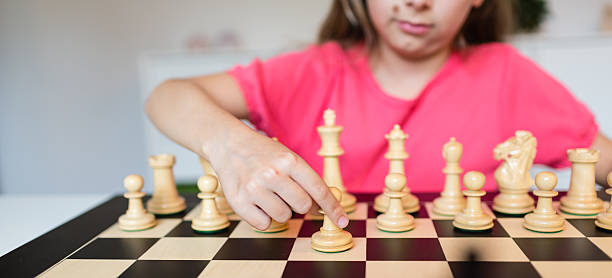 istock Girl and chess board 537873552
