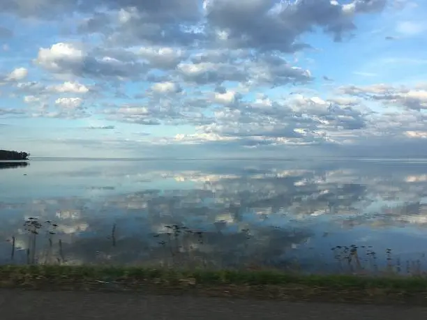 Blue and cloudy sky reflecting on beautiful Mille Lacs Lake in northern Minnesota