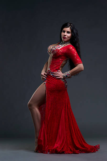 istock Exotic eastern women performs belly dance in ethnic red dress 537874460