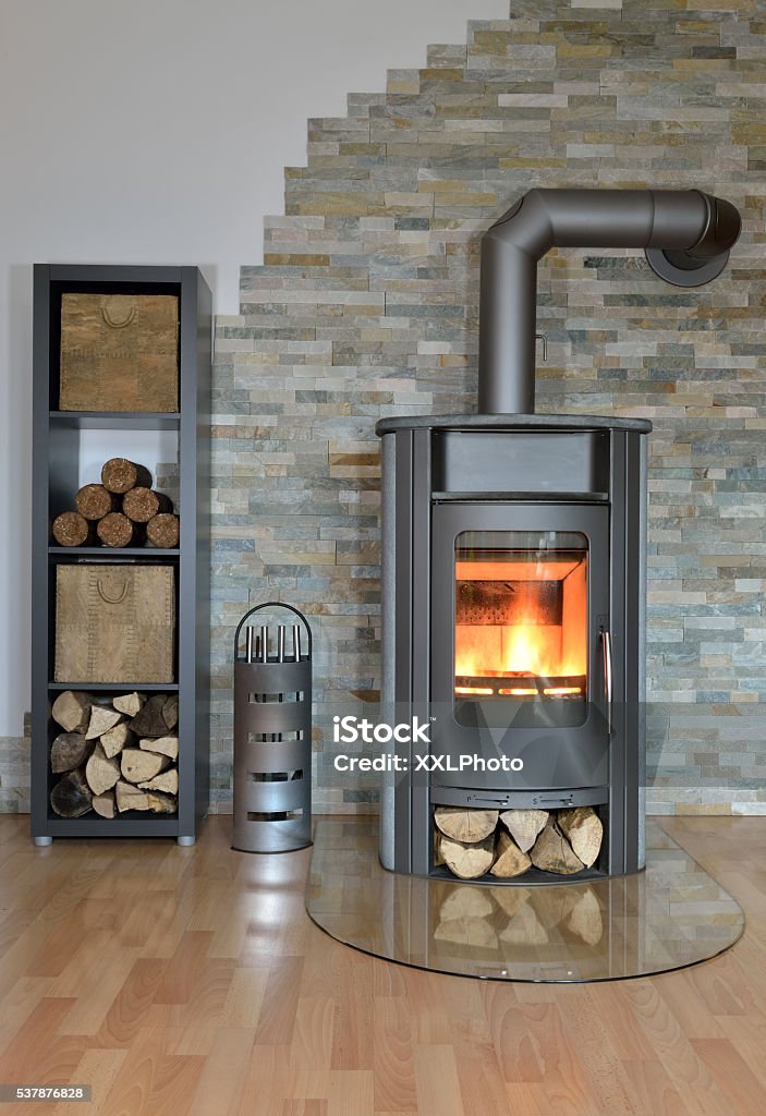 wood fired stove burning stove in living room in winter Brick Stock Photo