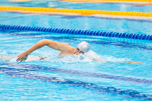 istock Man swimmer swimming crawl in blue water. 537879544