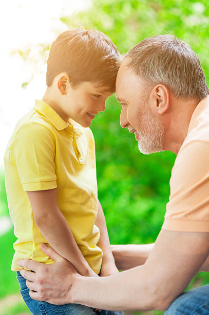 istock Cheerful old man and grandchild resting together 537881690