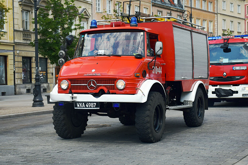 Warsaw, Poland - June 4, 2016: Mercedes Unimog in fire truck version driving on the street during the Fire Brigade Day. The Unimog is the one of the bravest truck on the off-road.