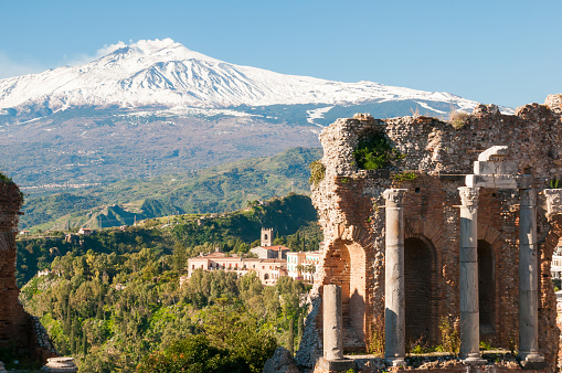 View of some columns in the stage of the greek theater in Taormina and a perspective of snowy mount EtnaView of some columns in the stage of the greek theater in Taormina and a perspective of snowy mount EtnaView of some columns in the stage of the greek theater in Taormina and a perspective of snowy mount Etna