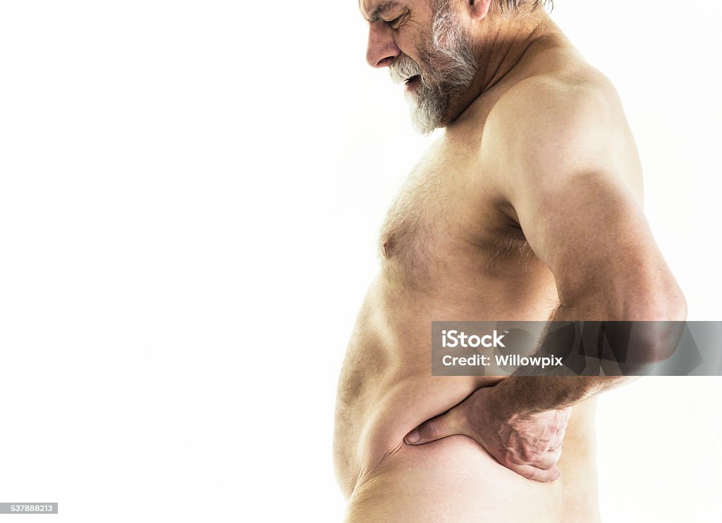 Overweight Senior Adult Man With Backache Pain An overweight senior adult man with backache pain is stretching and twisting his torso as he massages his back near his waist with his left hand to try to alleviate the pain. He works out regularly at an exercise fitness gym, so sometimes is sore here and there afterwards. Naked Stock Photo