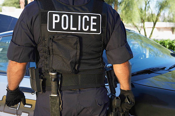 istock Policeman In Uniform Standing Against Car 537888975