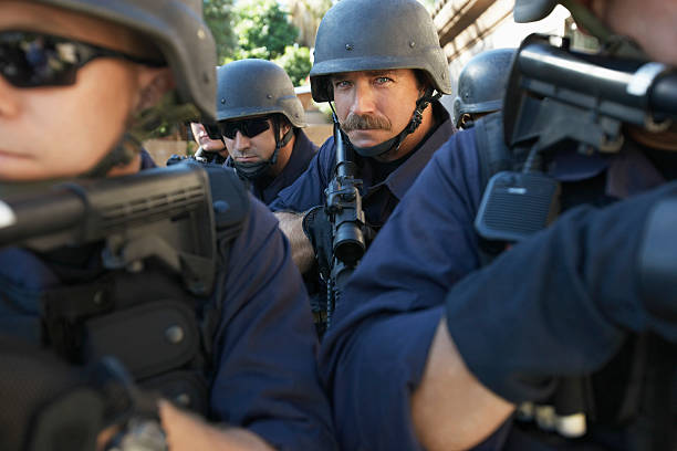istock Policeman Standing Admits Coworkers Aiming Guns 537888991