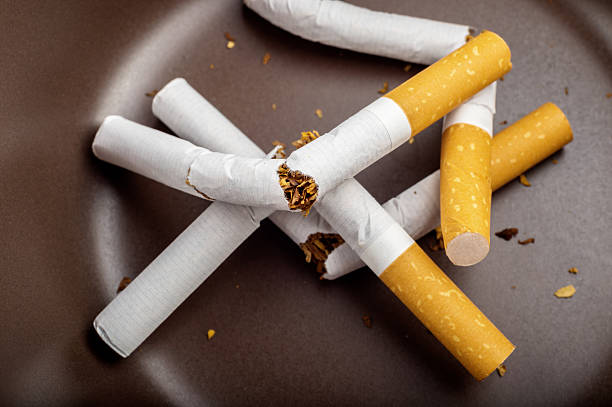 istock Quit Smoking - Broken unsmoked cigarettes in a white ashtray 537889564