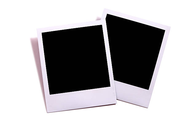 istock Two blank instant camera photo prints isolated on white 537890277