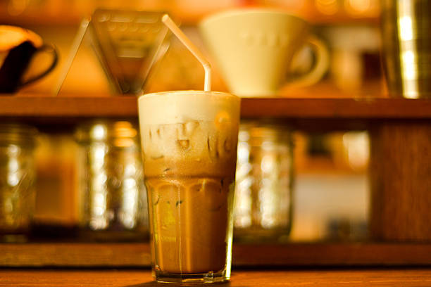 This is a horizontal close up shot of an iced coffee latte  in a coffee shop setting. This shot was taken in Chiang Mai, Thailand where hill tribe coffee is very popular.