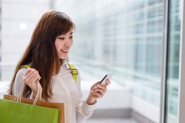 istock asian beautiful woman shopping and using smart phone indoor 537890725