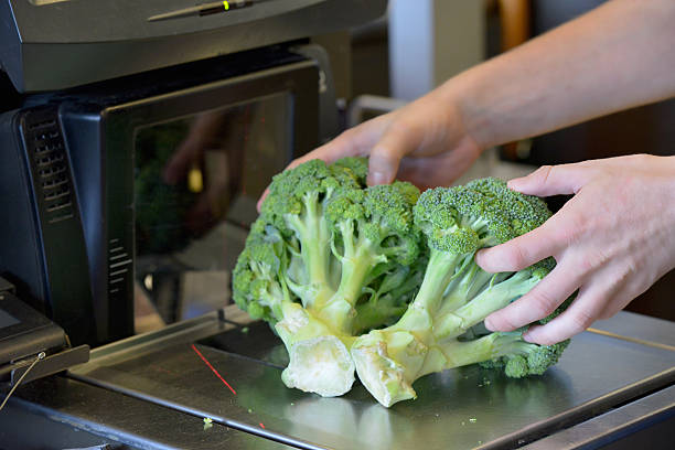 Weighing broccoli at a self check out at a supermarket