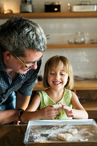 istock Little Girl Grandfather Bake Cookie Concept 537891276