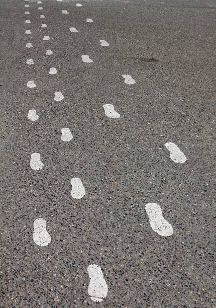 istock Painted Footsteps At A Busy Crosswalk 537892826