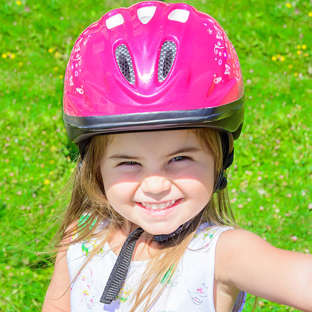 istock Girl wearing bicycle helmet 537894215