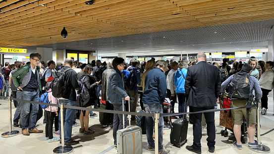 Amsterdam, Netherlands, The - May 23, 2016: Crowd people waiting in line for check-in  flight at Schipol Airpot in Amsterdam.