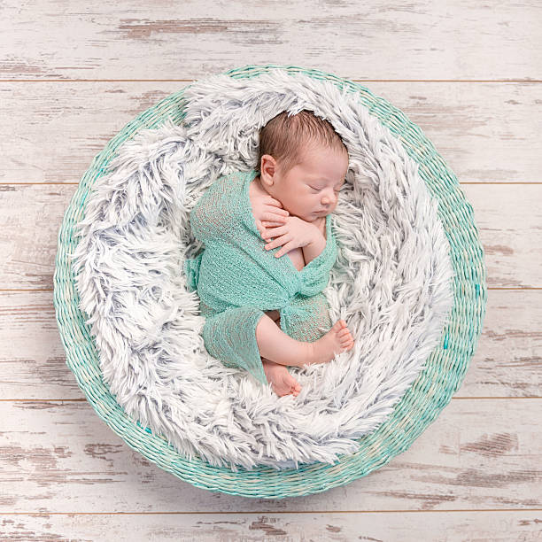 istock newborn baby peacefully sleeping in round cot 537898868