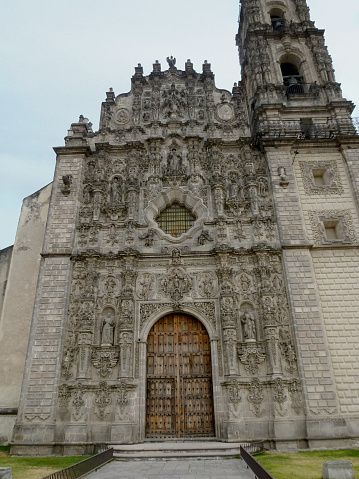 Tepotzotlán, Mexico - January 01, 2013: Facade of the San Francisco Javier Church which is no longer used for religious services and is now part of the Museo Nacional del Virreinato. His impressive interior contains one of the most important collections of Churrigueresque altarpieces in Mexico.