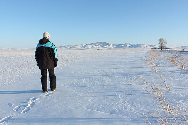 istock The man going on a snow field against mountains 537901290