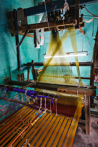 istock Man weaving silk sari on loom in India 537923819
