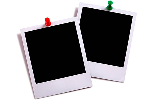 Two blank instant camera photo prints Two blank instant camera photo prints with green and red pushpins isolated on white with shadow.  Space for copy. two objects photos stock pictures, royalty-free photos & images