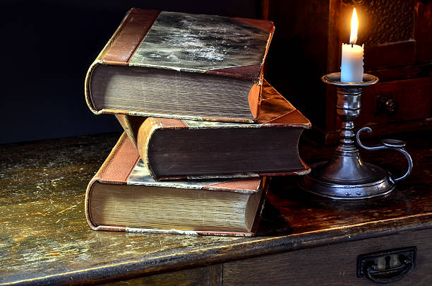 istock Old books and candle 537923853