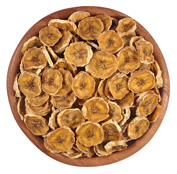 istock Dried bananas in a wooden bowl on a white 537924353