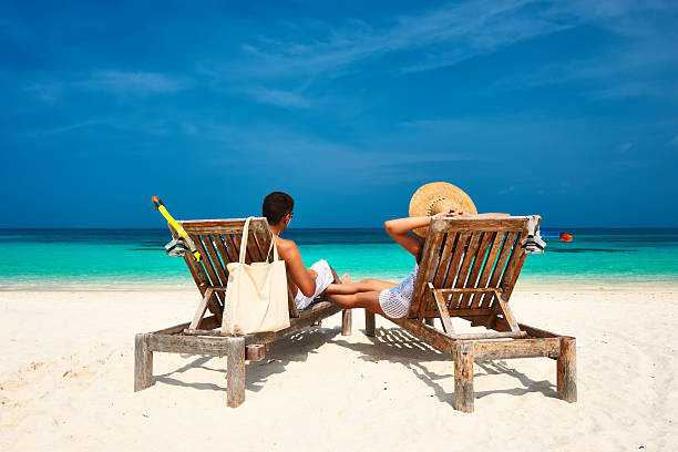 istock Couple in white relax on a beach at Maldives 537925375