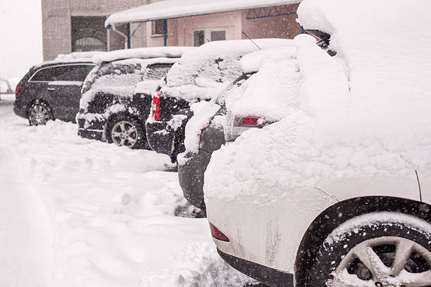 istock Snow-covered cars during a winter blizzard 537925451